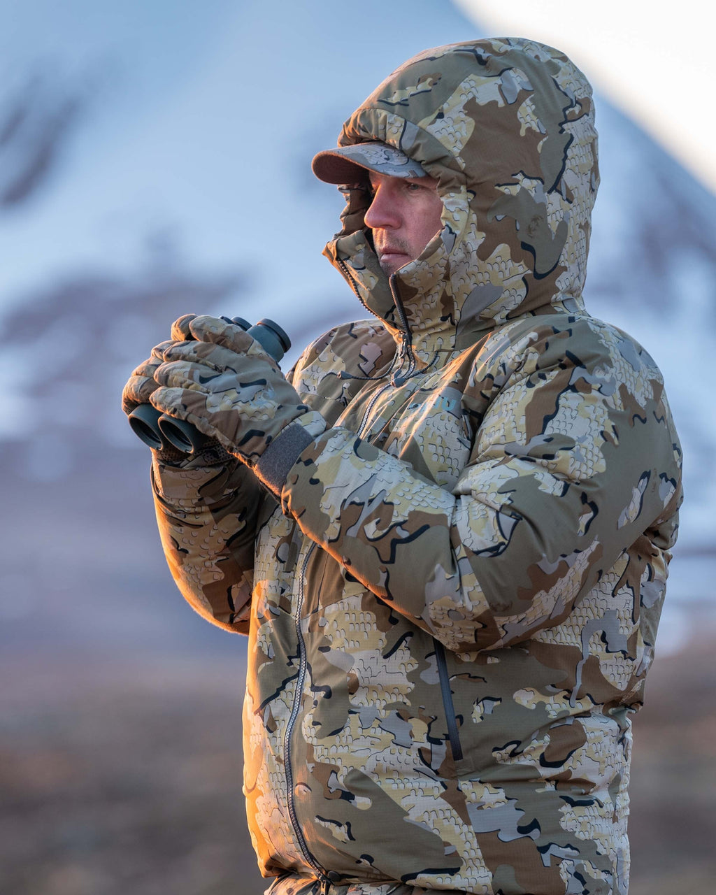 Side of Hunter Glassing Game Wearing Kenai Packable Gloves in Valo Camouflage