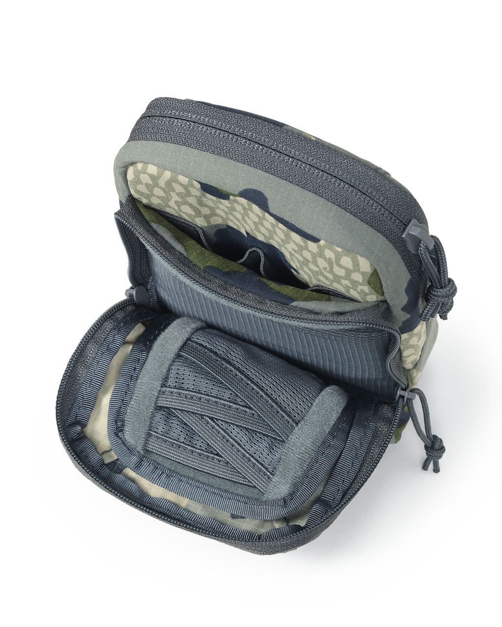 Unzipped front pouch of the Slate Call Holder in Verde Camouflage, Featuring internal mesh divide pockets for storage