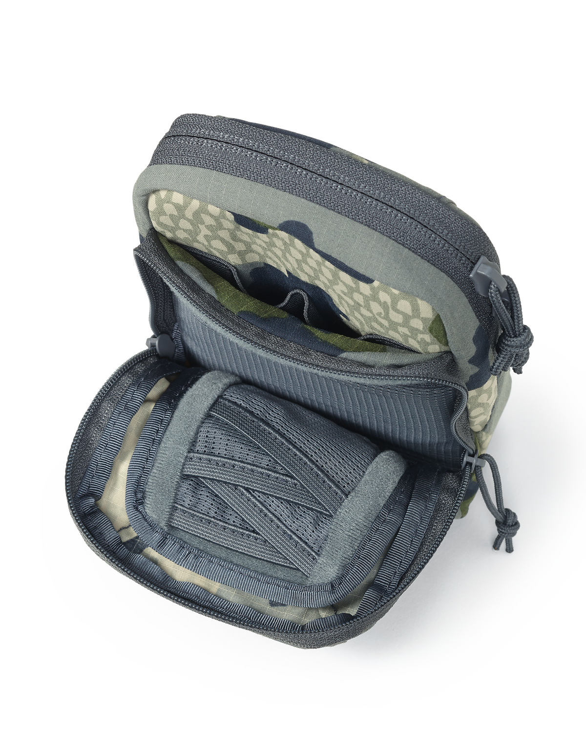 Unzipped front pouch of the Slate Call Holder in Verde Camouflage, Featuring internal mesh divide pockets for storage