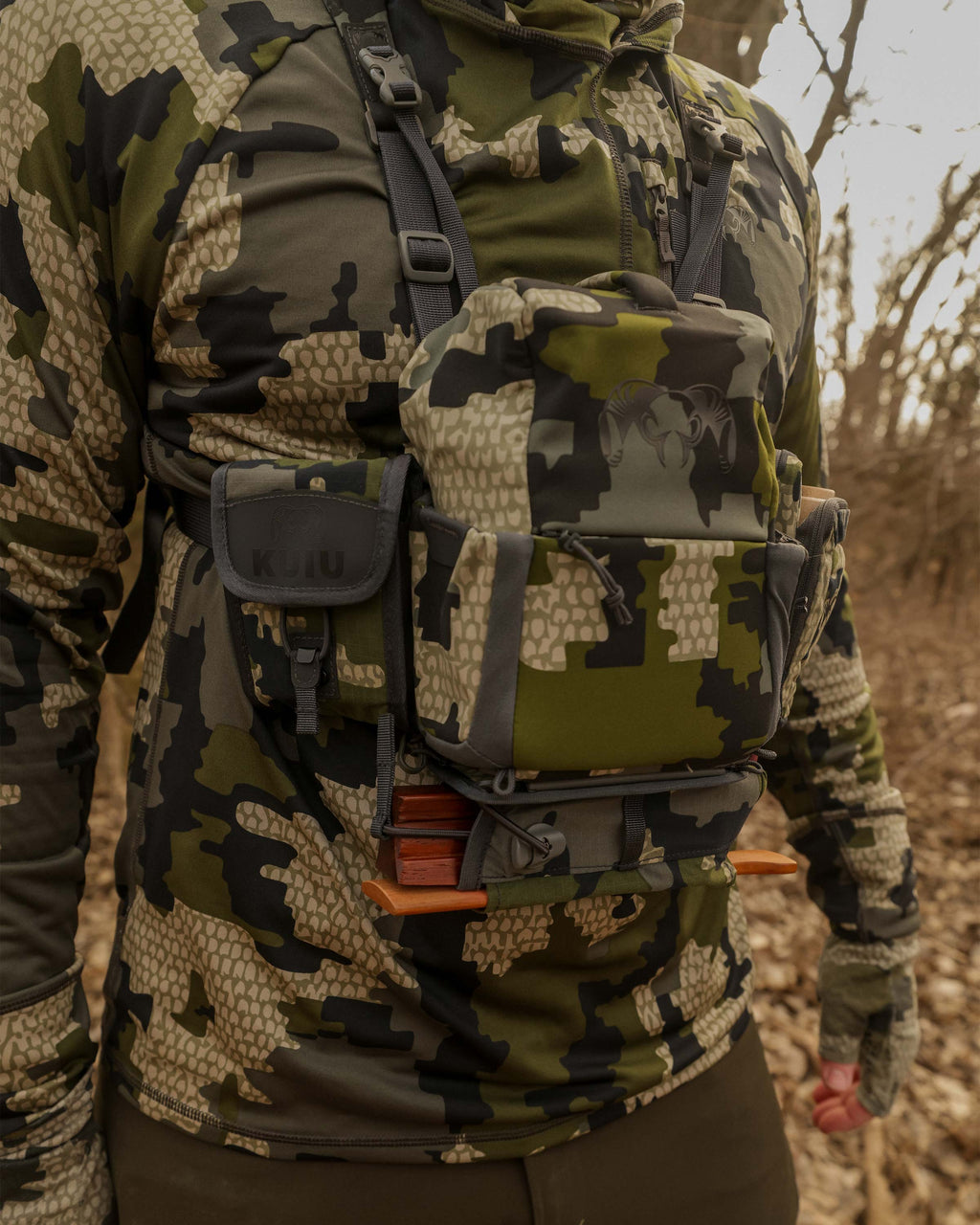 Front of Hunter wearing PRO G3 Bino Harness with PRO G3 Turkey Kit in Verde Camouflage, Includes: Box Call Holder, Slate Call Holder and Rangefinder Holder