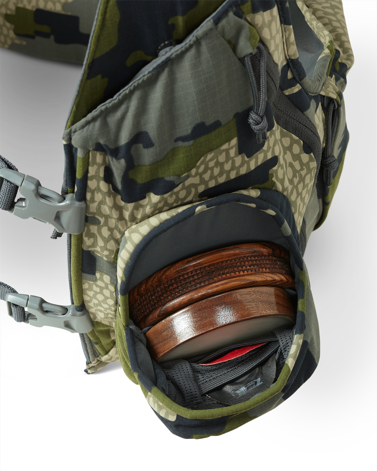 Inside view of front pocket on the Rival Turkey Vest in Verde Camouflage stowed with a slate pot call