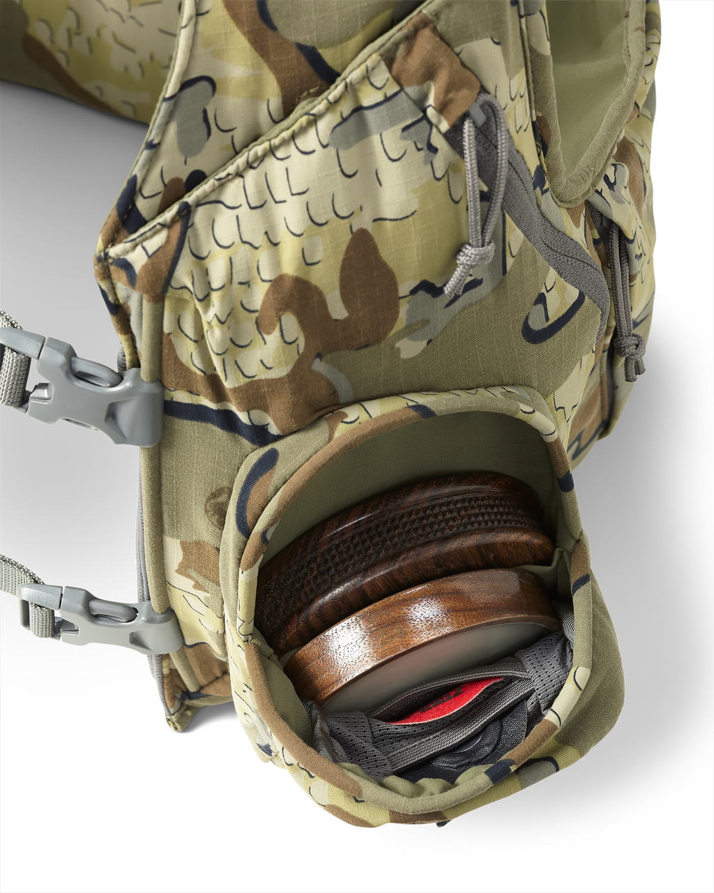 Inside view of front pocket on the Rival Turkey Vest in Valo Camouflage stowed with a slate pot call