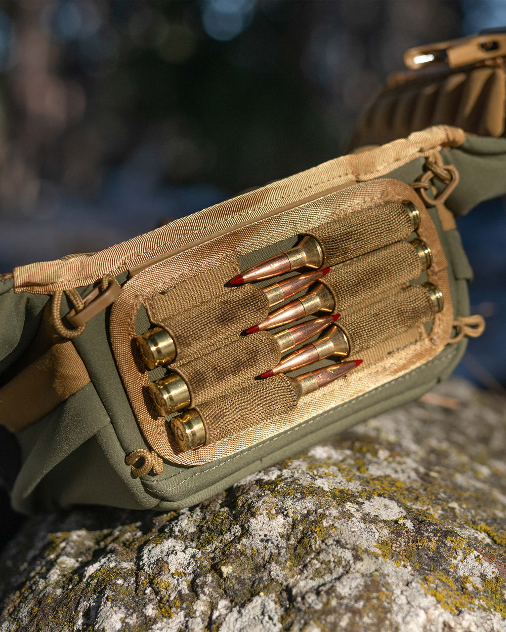 Close-up, bottom view of PRO Chest Pack in Evergreen, Highlighting bottom of the main compartment, features an innovative dual track connection system for the ammo holder accessory