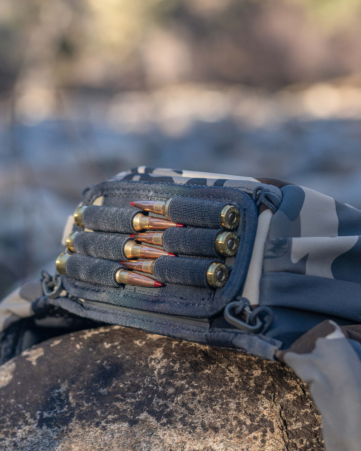 Close-up, bottom view of PRO Chest Pack in Vias Camouflage, Highlighting bottom of the main compartment, features an innovative dual track connection system for the ammo holder accessory