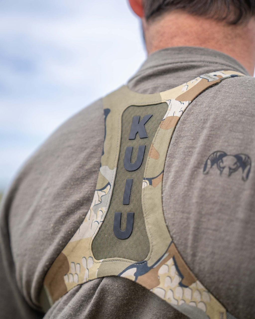 Close-up, back view of Ultralight Bino Harness in Valo Camouflage, Highlighting vented mesh harness and silicone print of KUIU lettering 
