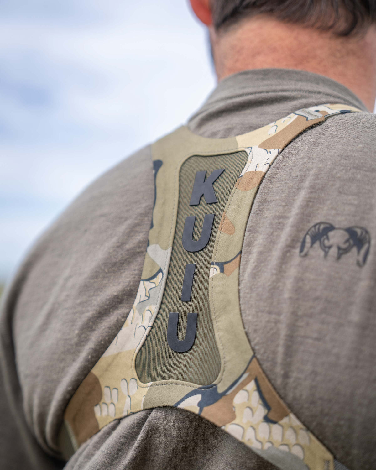 Close-up, back view of Ultralight Bino Harness in Valo Camouflage, Highlighting vented mesh harness and silicone print of KUIU lettering 
