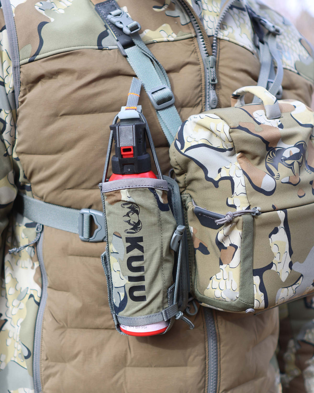 Front of Hunter wearing PRO Bino Harness with PRO G3 Bear Spray Holder in Valo Camouflage attached on the right side