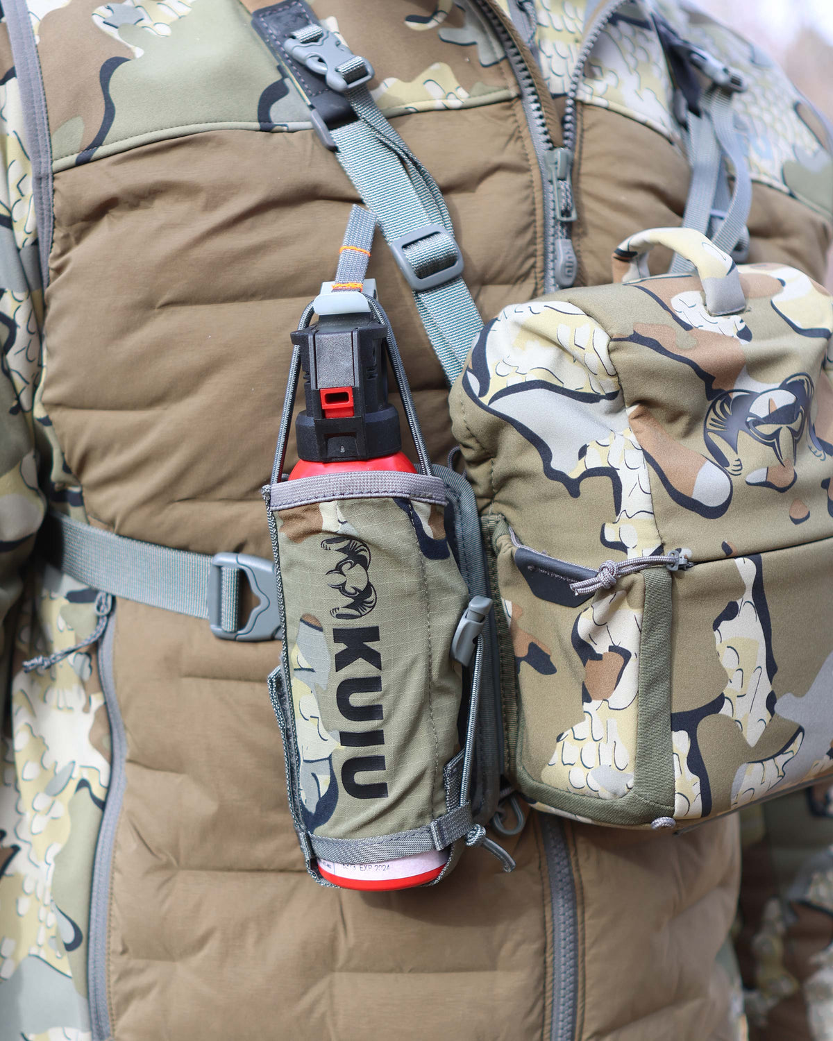 Front of Hunter wearing PRO Bino Harness with PRO G3 Bear Spray Holder in Valo Camouflage attached on the right side