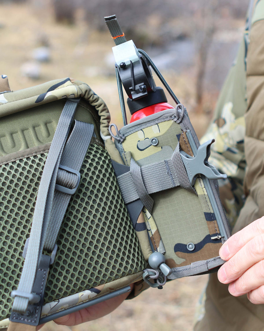 Backside view of the PRO G3 Harness in Valo Camouflage attached to the PRO G3 Bear Spray Holder in Valo Camouflage, displaying attachment point