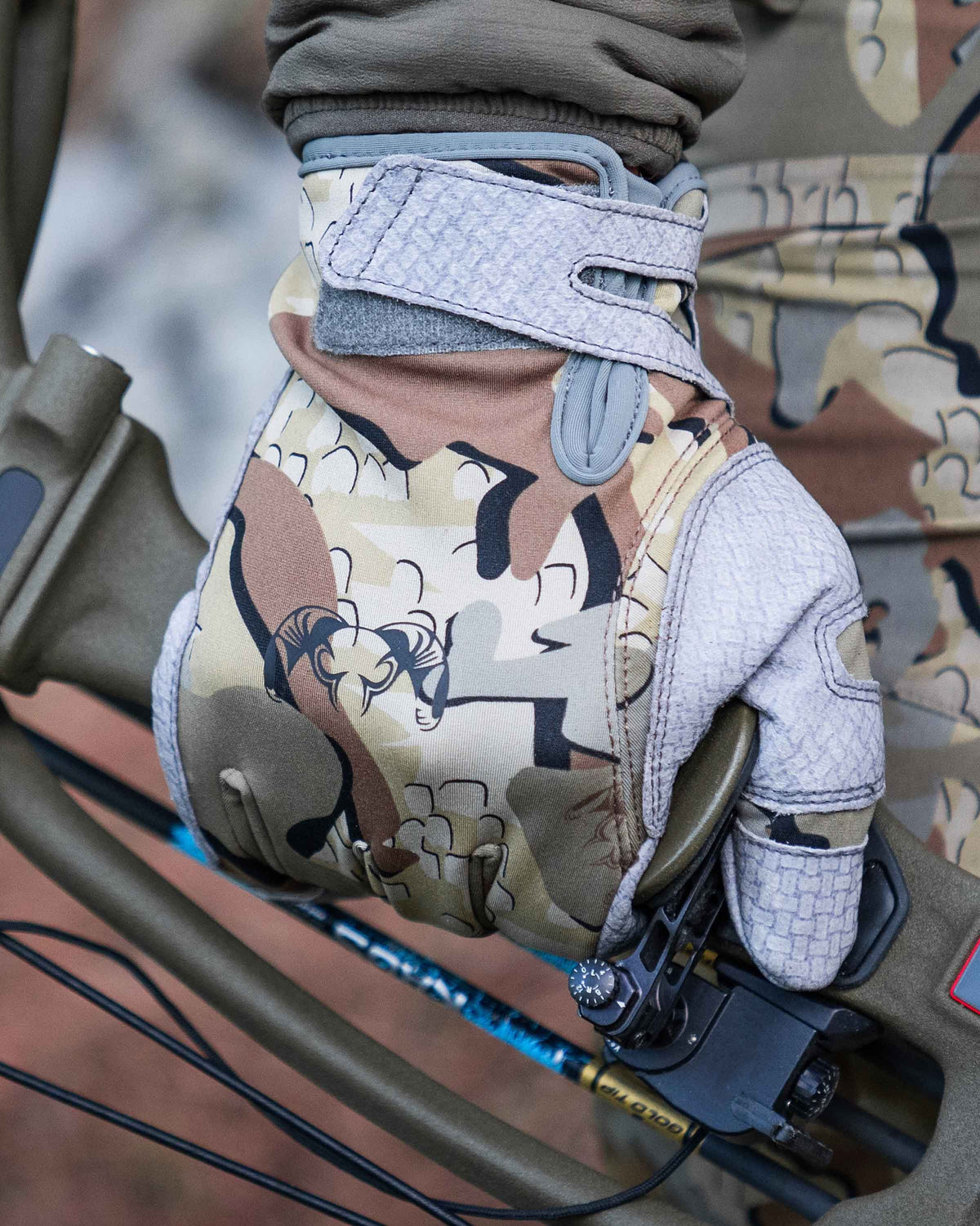 Close View of Hunter Holding Binoculars with Attack Gloves in Valo Camouflage
