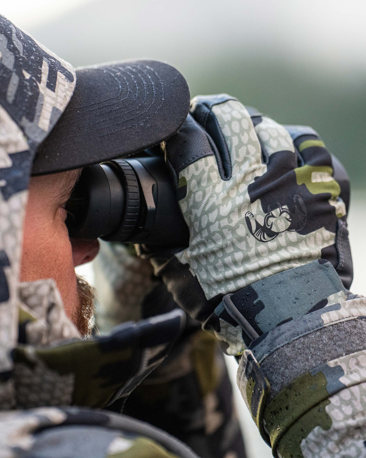 Close-up of hunter glassing wearing Precision Glove in Verde Camouflage