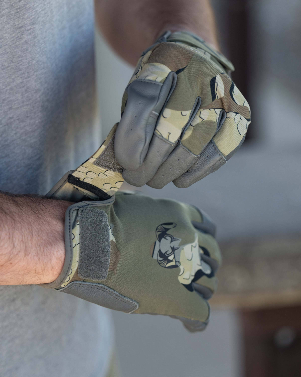 Hunter wearing Precision Glove in Valo Camouflage adjusting hook-and-loop wrist closure
