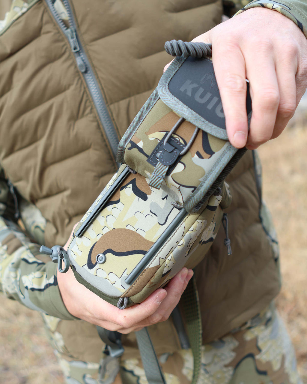 Hunter using rail-lock connection, attaching the PRO G3 Rangefinder Holder in Valo Camouflage to the bottom of the PRO G3 Bino Harness