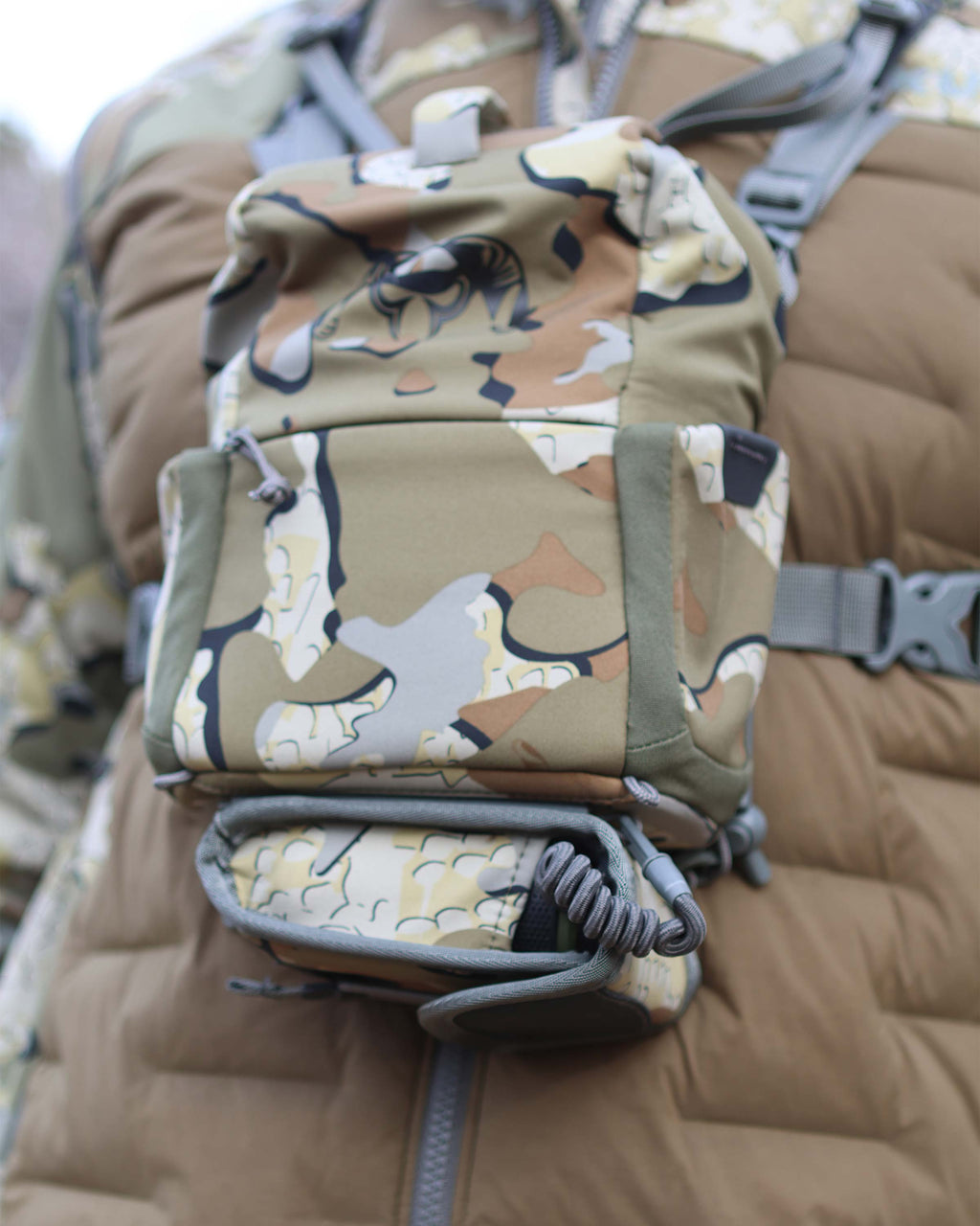 Close-up view of PRO G3 Rangefinder Holder in Valo Camouflage attached to the bottom of PRO G3 Bino Harness in Valo Camouflage