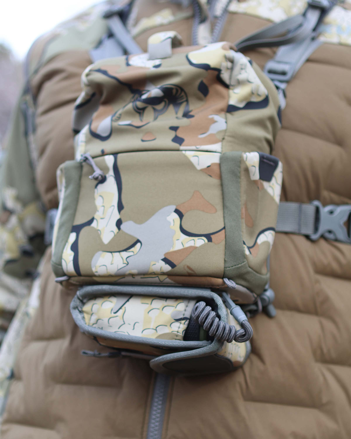 Close-up view of PRO G3 Rangefinder Holder in Valo Camouflage attached to the bottom of PRO G3 Bino Harness in Valo Camouflage