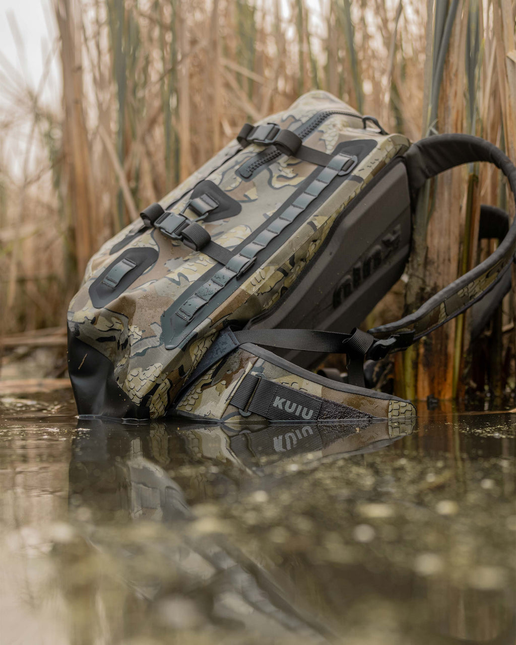 Delta Storm 2200 Submersible Backpack floating in water showcasing side angle in Valo Camouflage