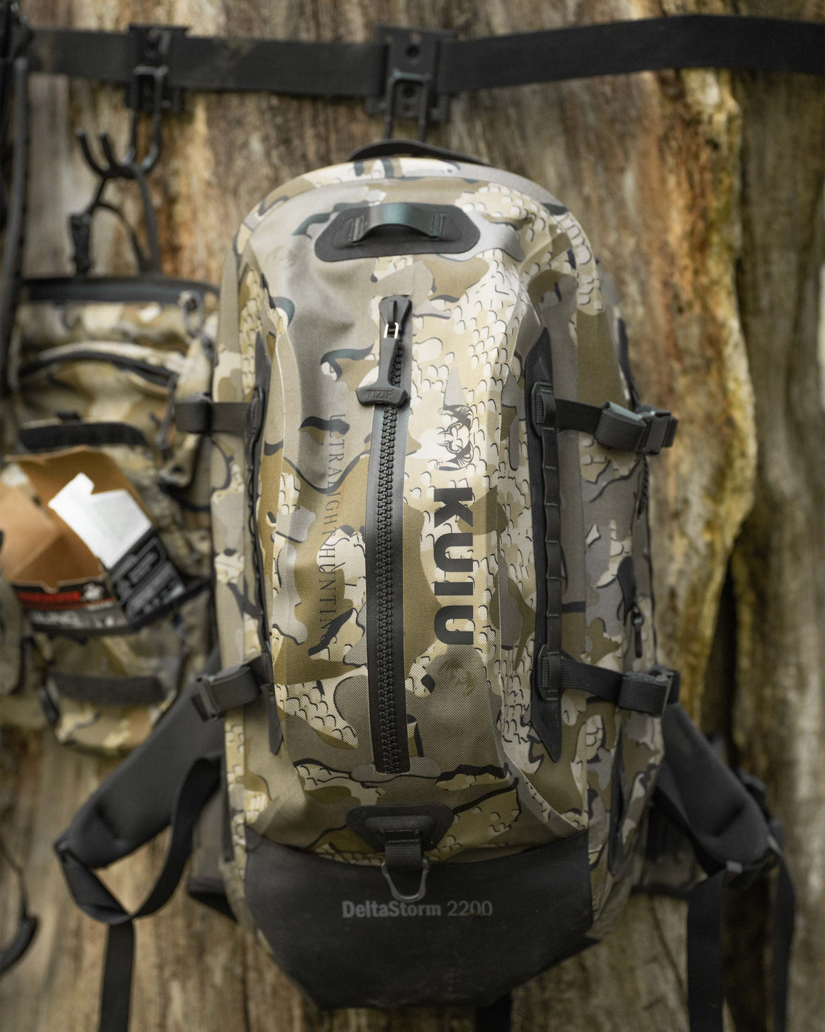 Delta Storm 2200 Submersible Backpack Hanging up on a tree zoomed in slightly to show sipper and detail in Valo Camouflage