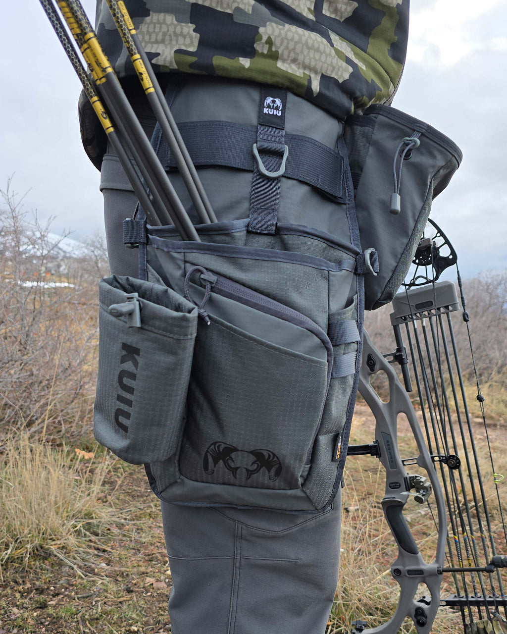 Archery Hip Quiver in Gunmetal Attached to Mans right leg, side angle shot