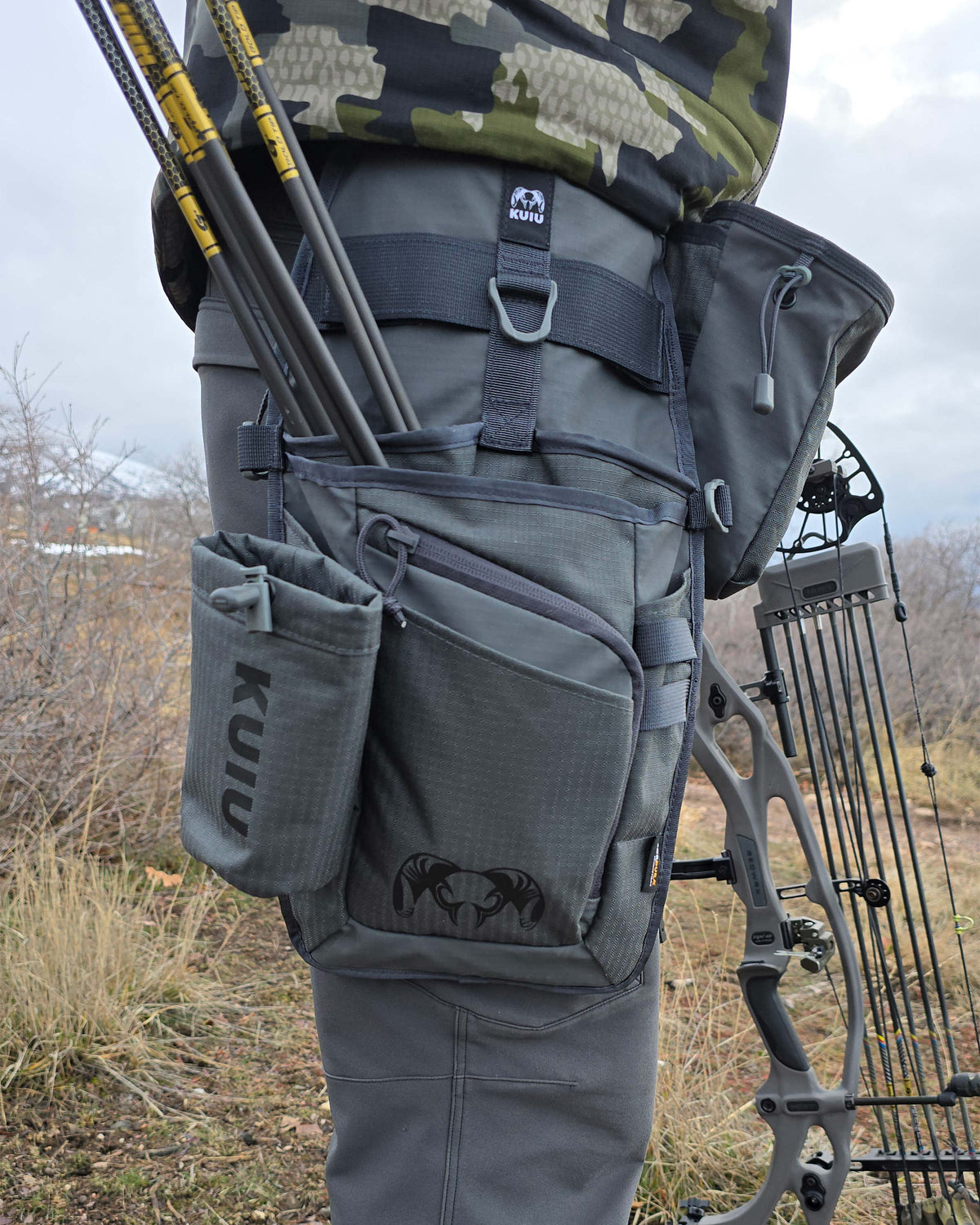 Archery Hip Quiver in Gunmetal Attached to Mans right leg, side angle shot