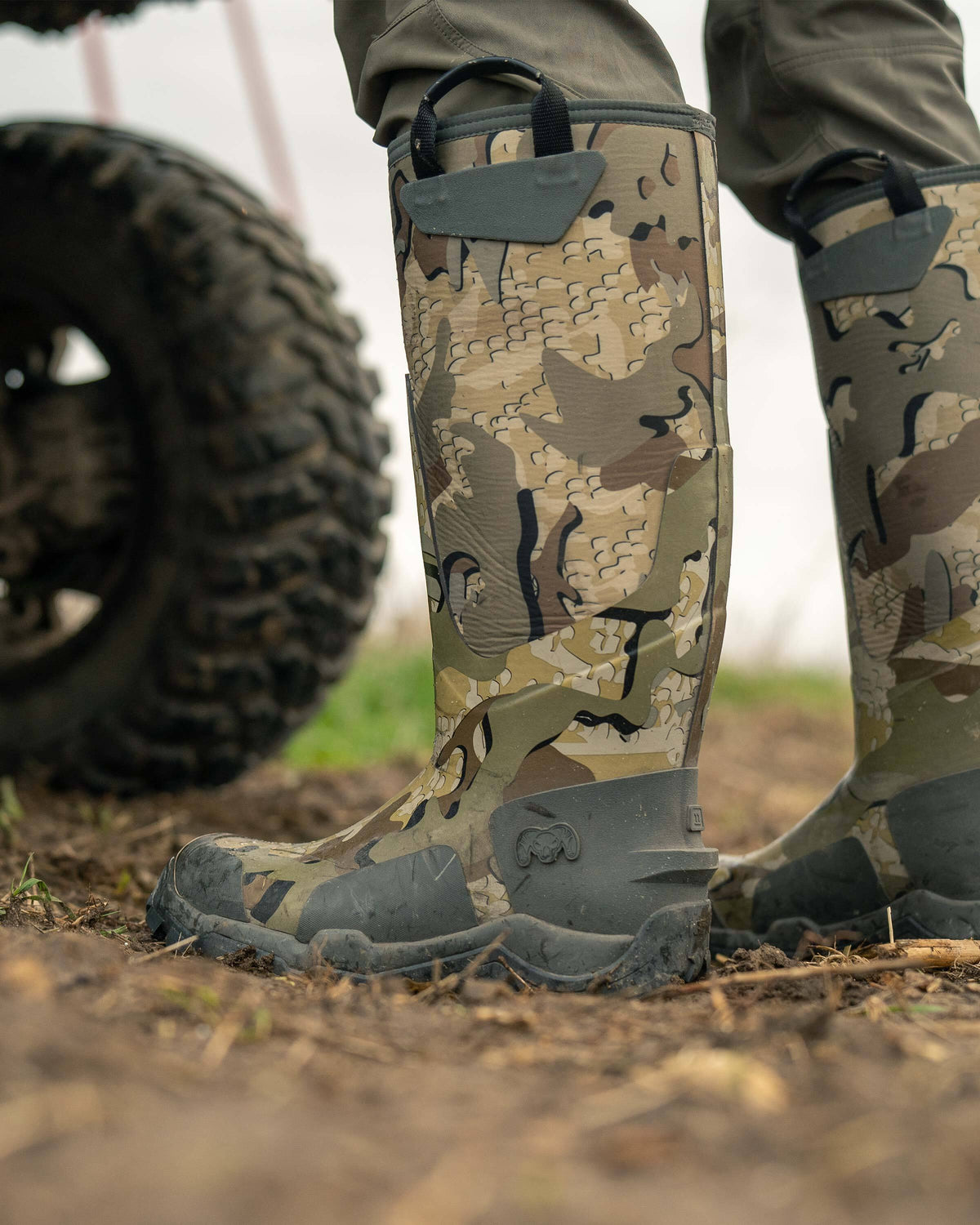Outdoor setting, close-up side view of KUIU Mud Boot in Valo Camouflage 