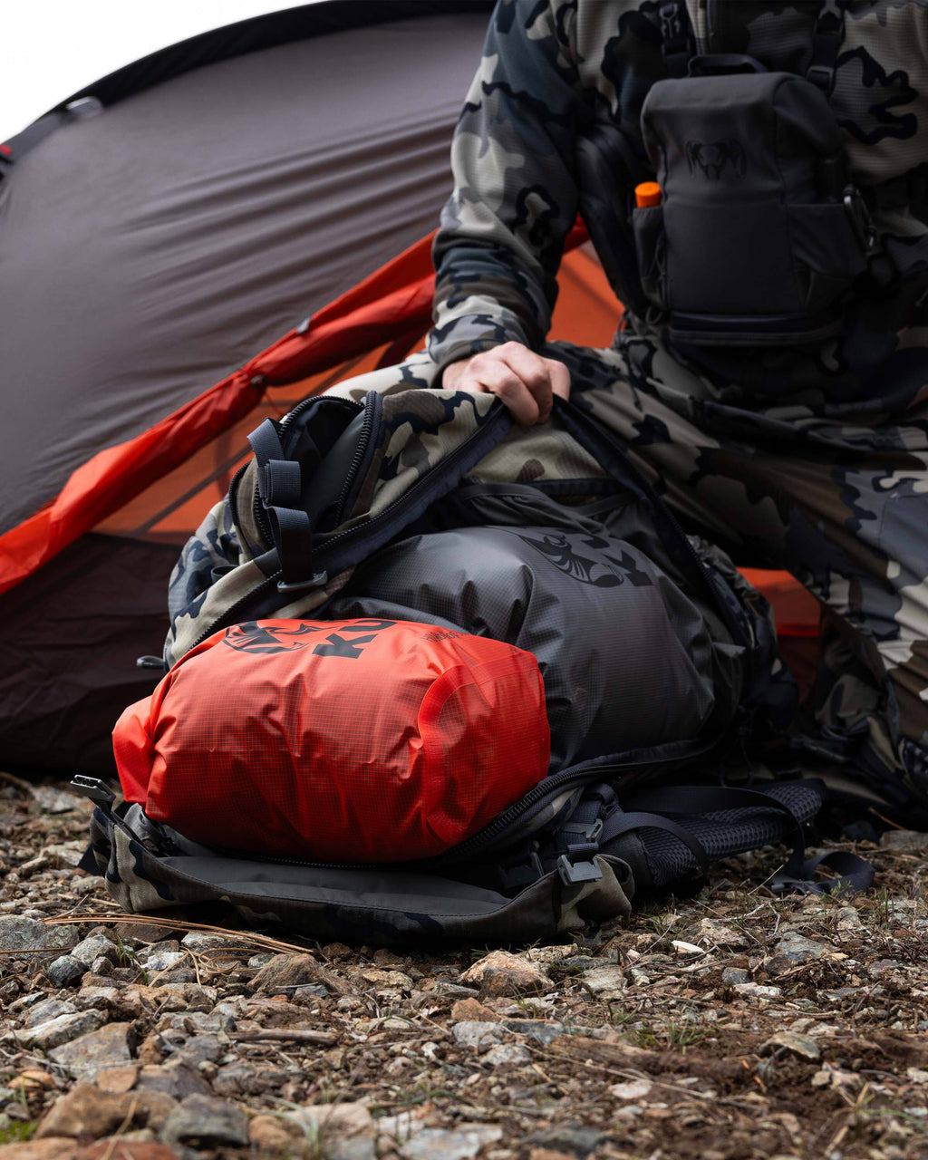 Picture showing both a Blaze Orange and a Stone Grey HD Roll Top Dry Bag laid inside of a pack