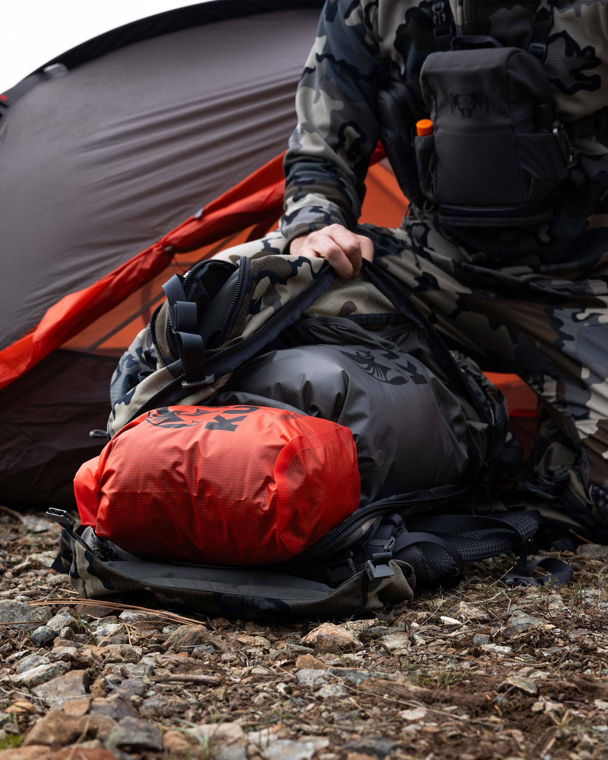Picture showing both a Blaze Orange and a Stone Grey HD Roll Top Dry Bag laid inside of a pack