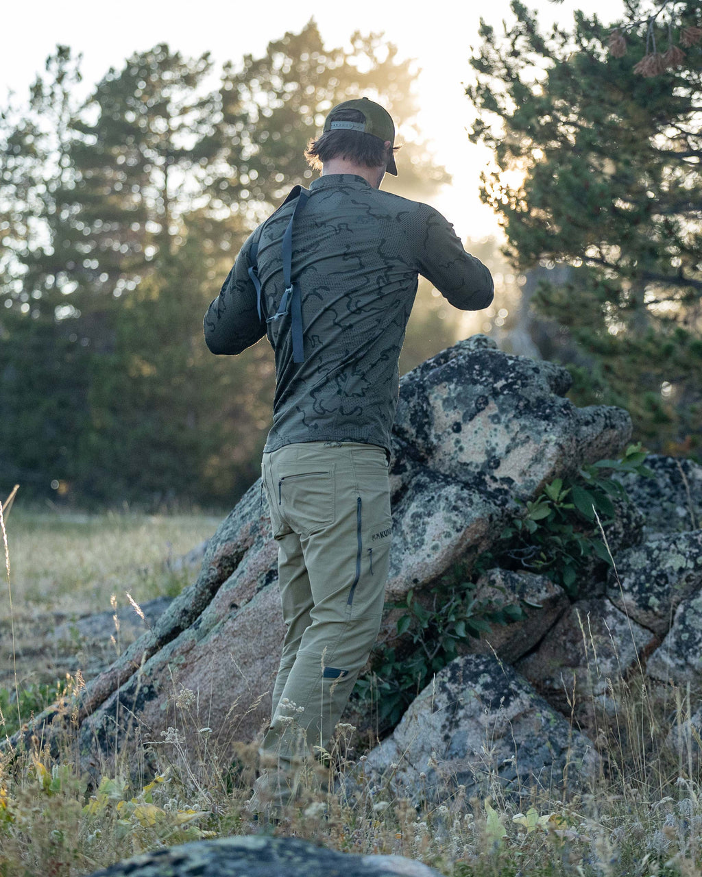 Back view of Hunter wearing Ridgepoint Fleece Henley in Olive Green Tonal Pattern