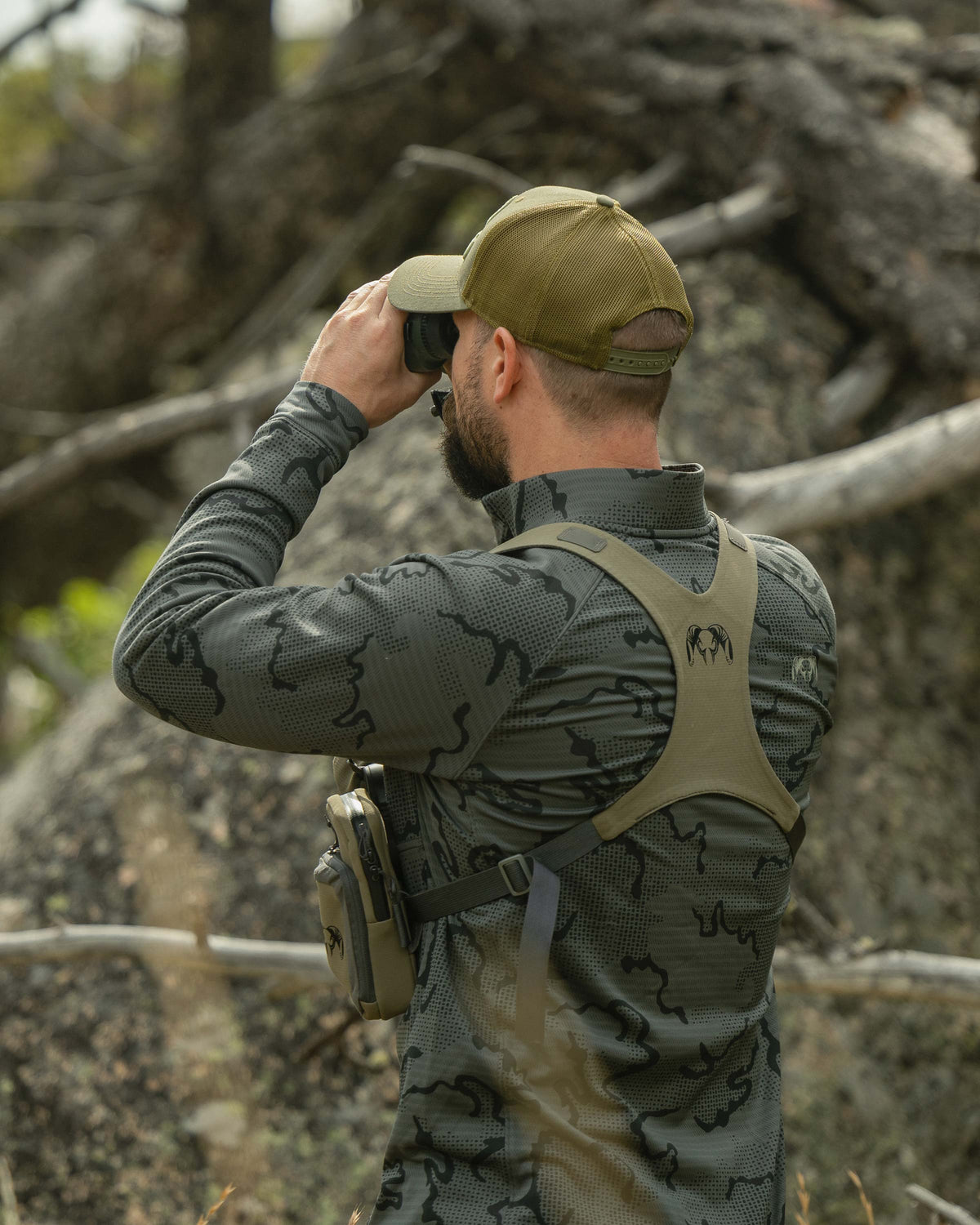 Back view of Hunter glassing, wearing Ridgepoint Fleece Zip-T in Olive Green Tonal Pattern 