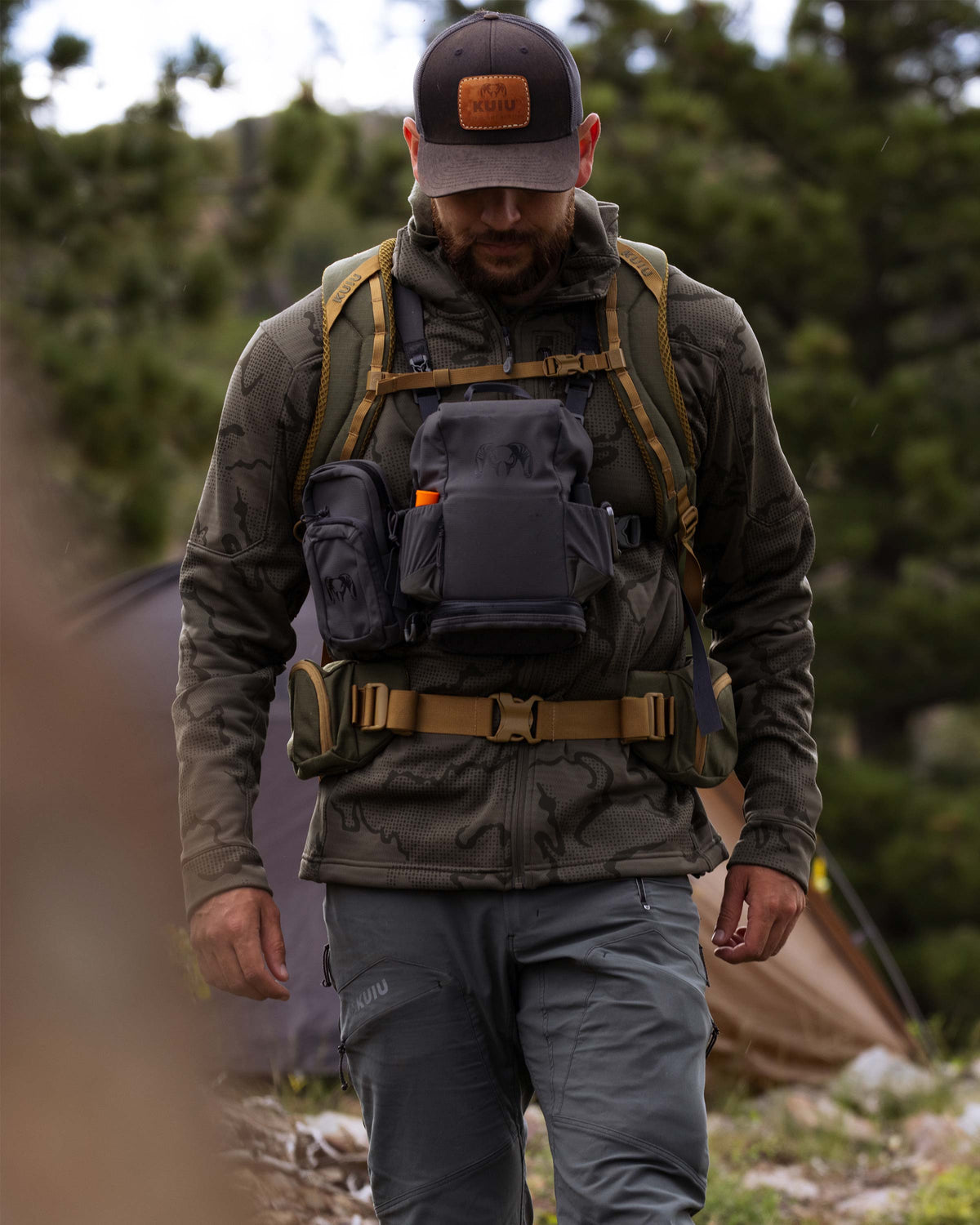 Hunter in an outdoor setting backpacking, wearing Ridgepoint Fleece Hoodie in Ash Tonal Brown