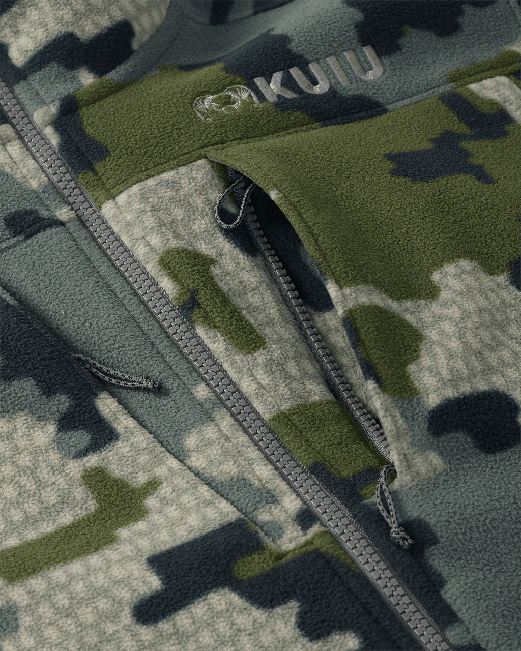 Close-up of front unzipped chest pocket and embroidered KUIU logo on Proximity LT Hooded Jacket in Verde Camouflage