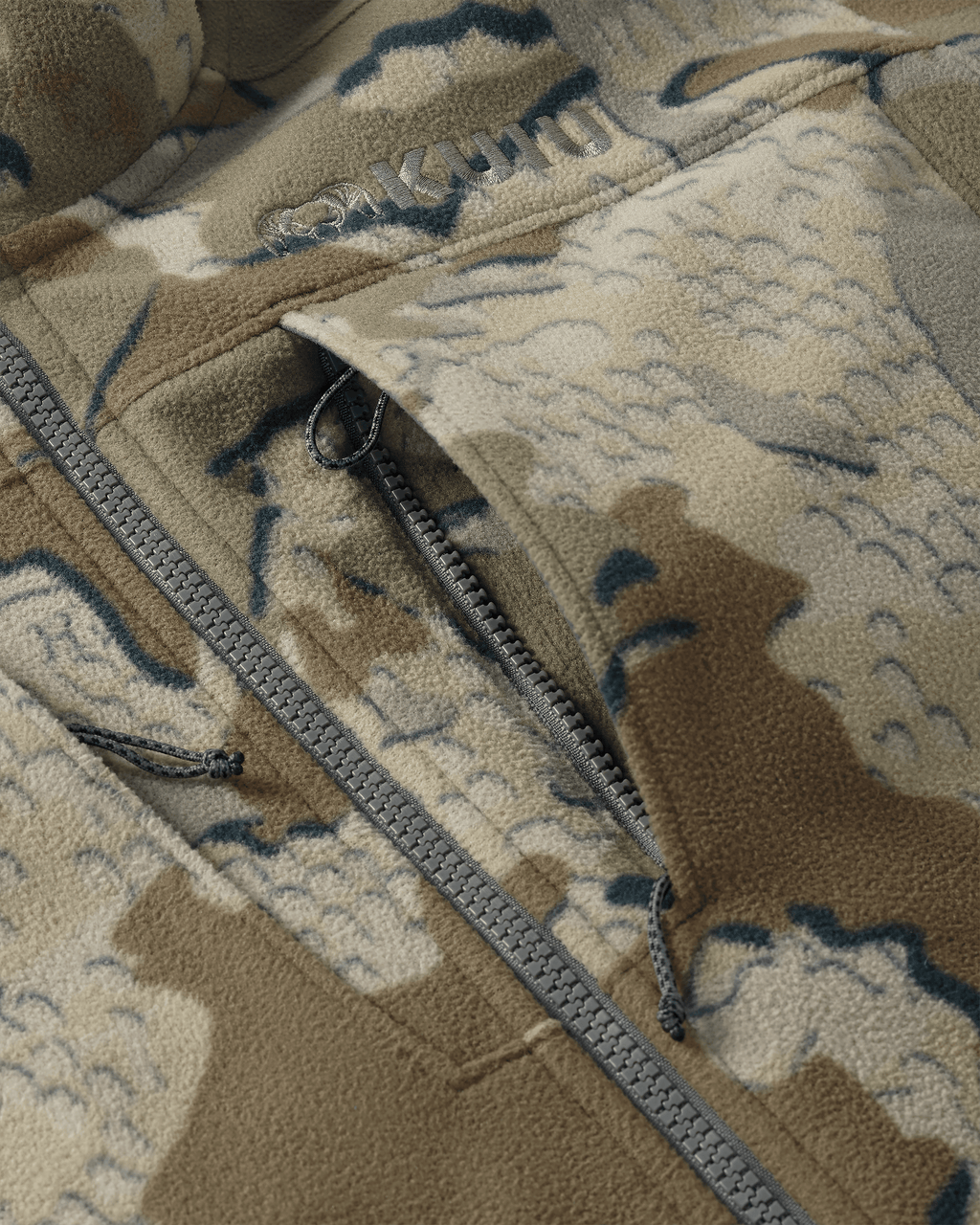 Close-up of front unzipped chest pocket and embroidered KUIU logo on Proximity LT Hooded Jacket in Valo Camouflage