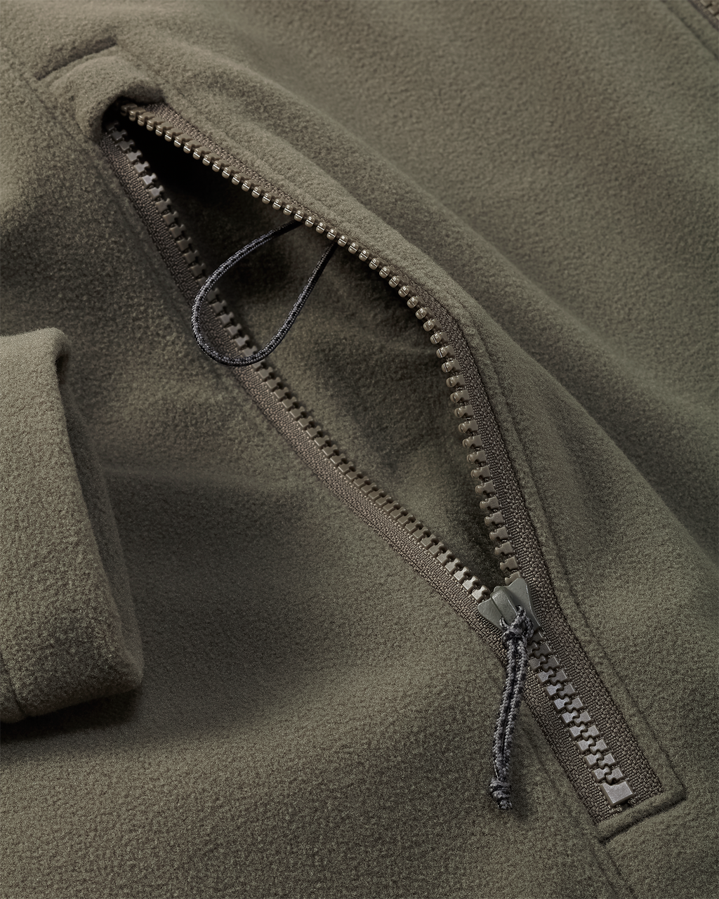 Close-up of zippered pocket with inside  lanyard connection loop on the Border Fleece Full Zip Jacket in Ash Brown