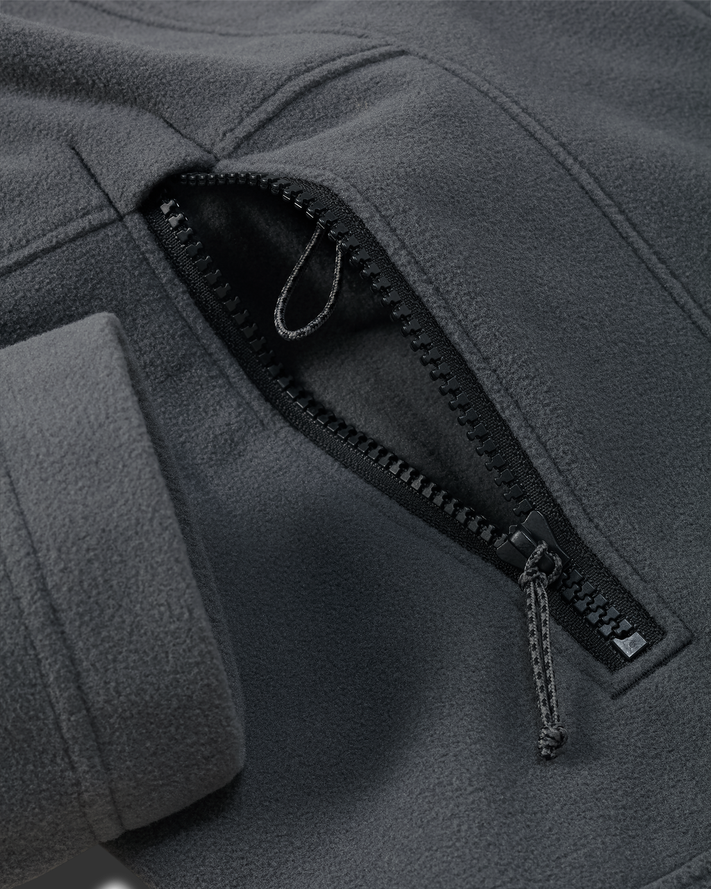 Zippered hand pocket with accessory connection lanyard on the KUIU Women's Border Fleece Jacket in Gunmetal Grey.