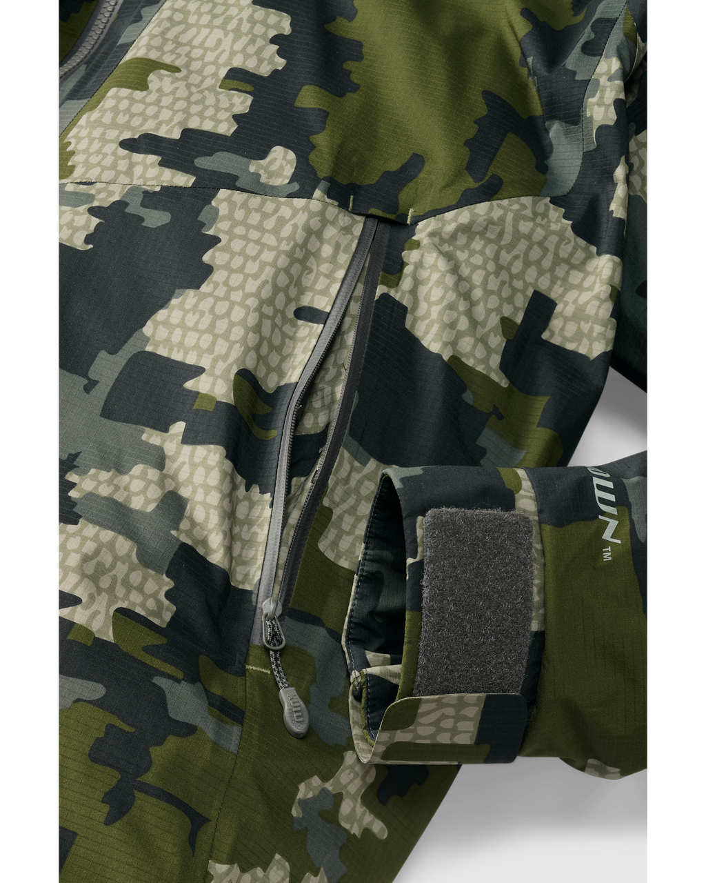 Bottom of Super Down Burner Parka in Verde Camouflage Highlighting YKK Aquaguard Zippered Hand Pocket and Adjustable Cuff