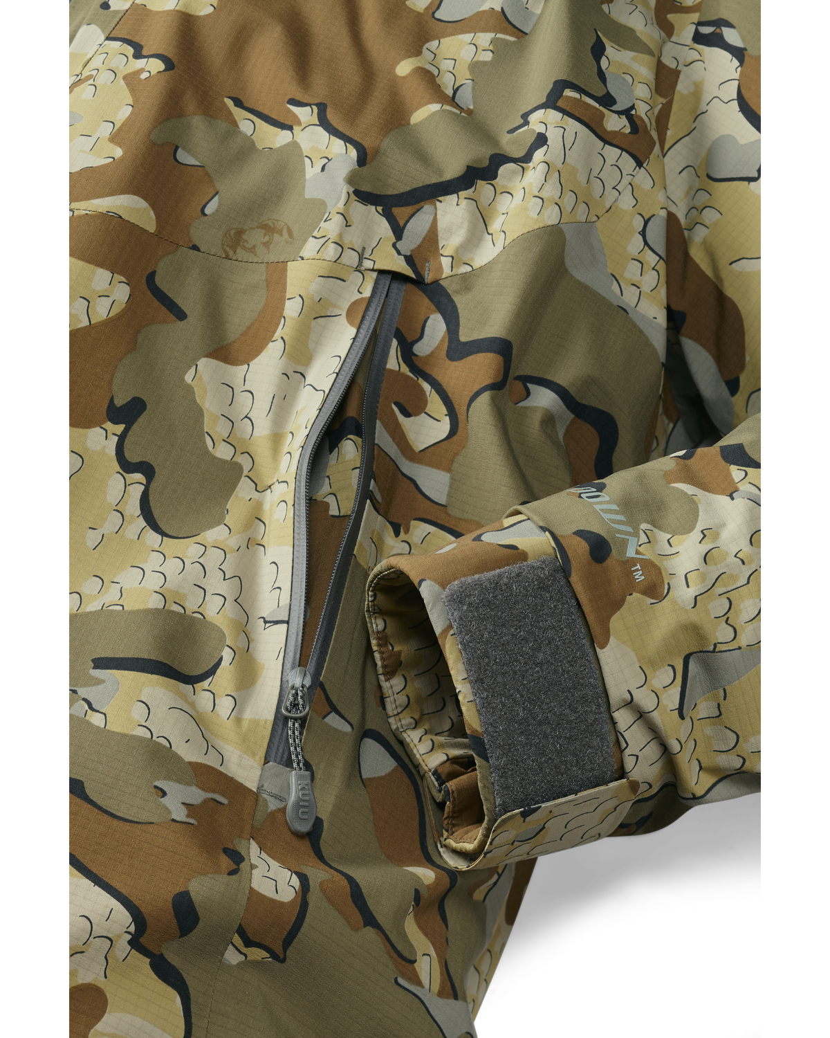 Bottom of Super Down Burner Parka in Valo Camouflage Highlighting YKK Aquaguard Zippered Hand Pocket and Adjustable Cuff
