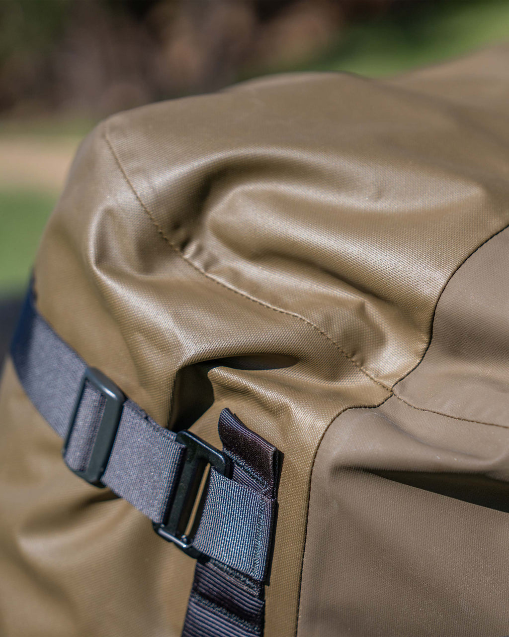 Close-up of seams and side shoulder straps on the Taku BLSTX Duffel in Bourbon Brown
