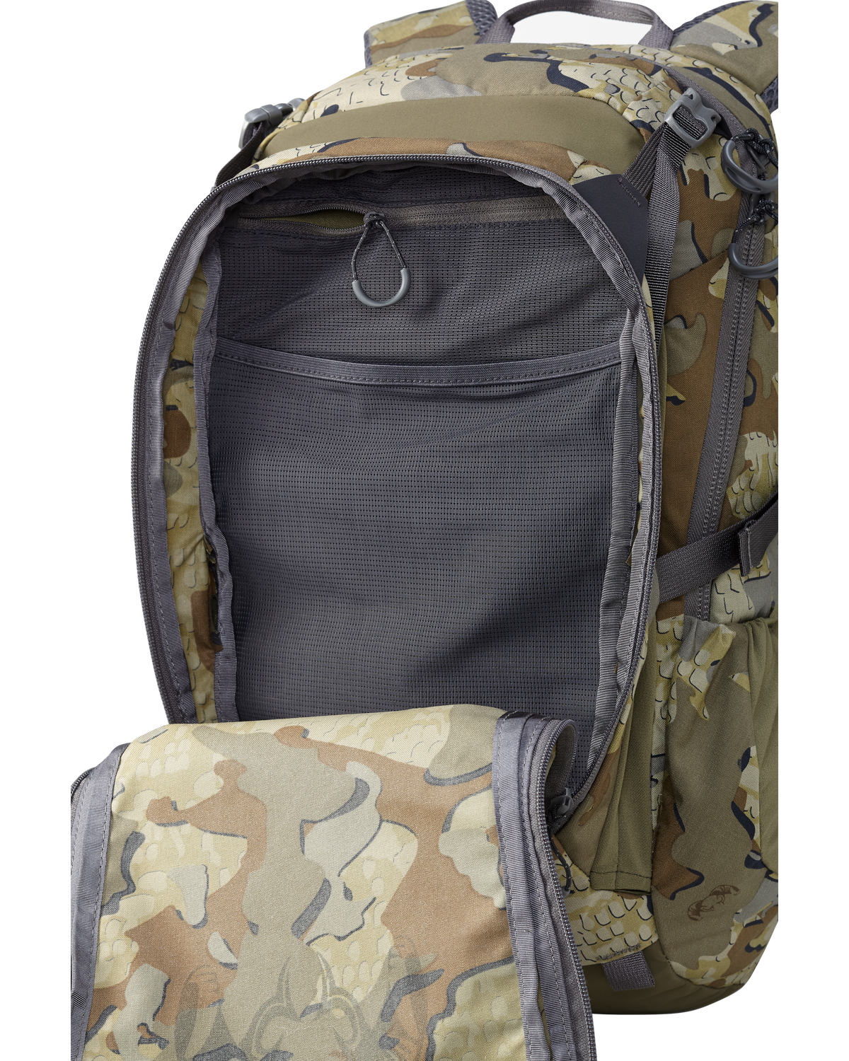 Divide 1200 Backpack in Valo Camouflage with front zippered pocket open to show storage