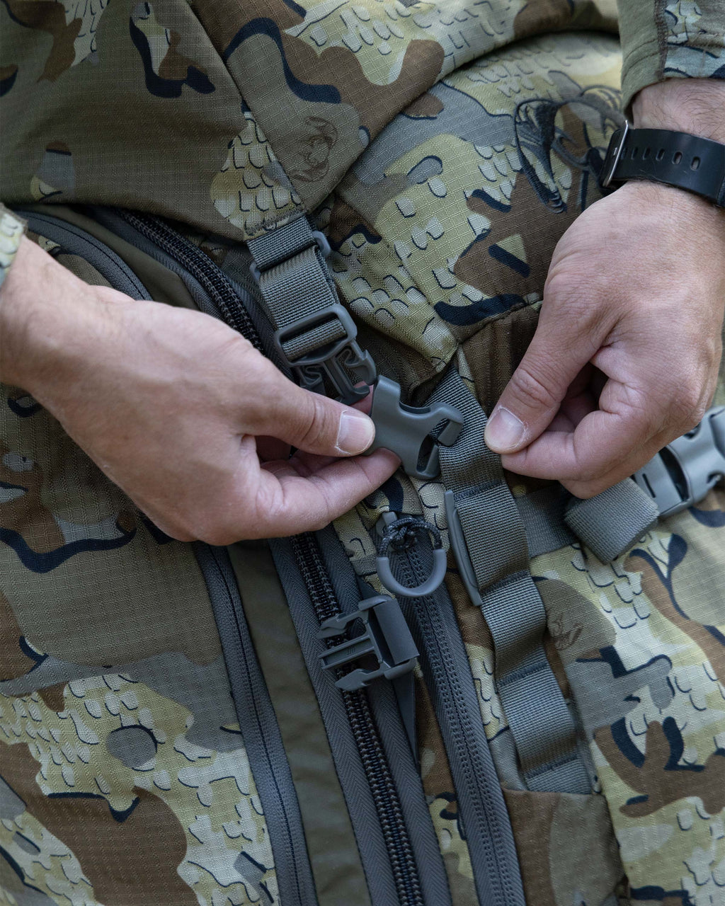 Close-up of adjustable and removable compression straps woven through a daisy-chain webbing system with locking buckles on an ICON 6 6000 Pack in Valo Camouflage.
