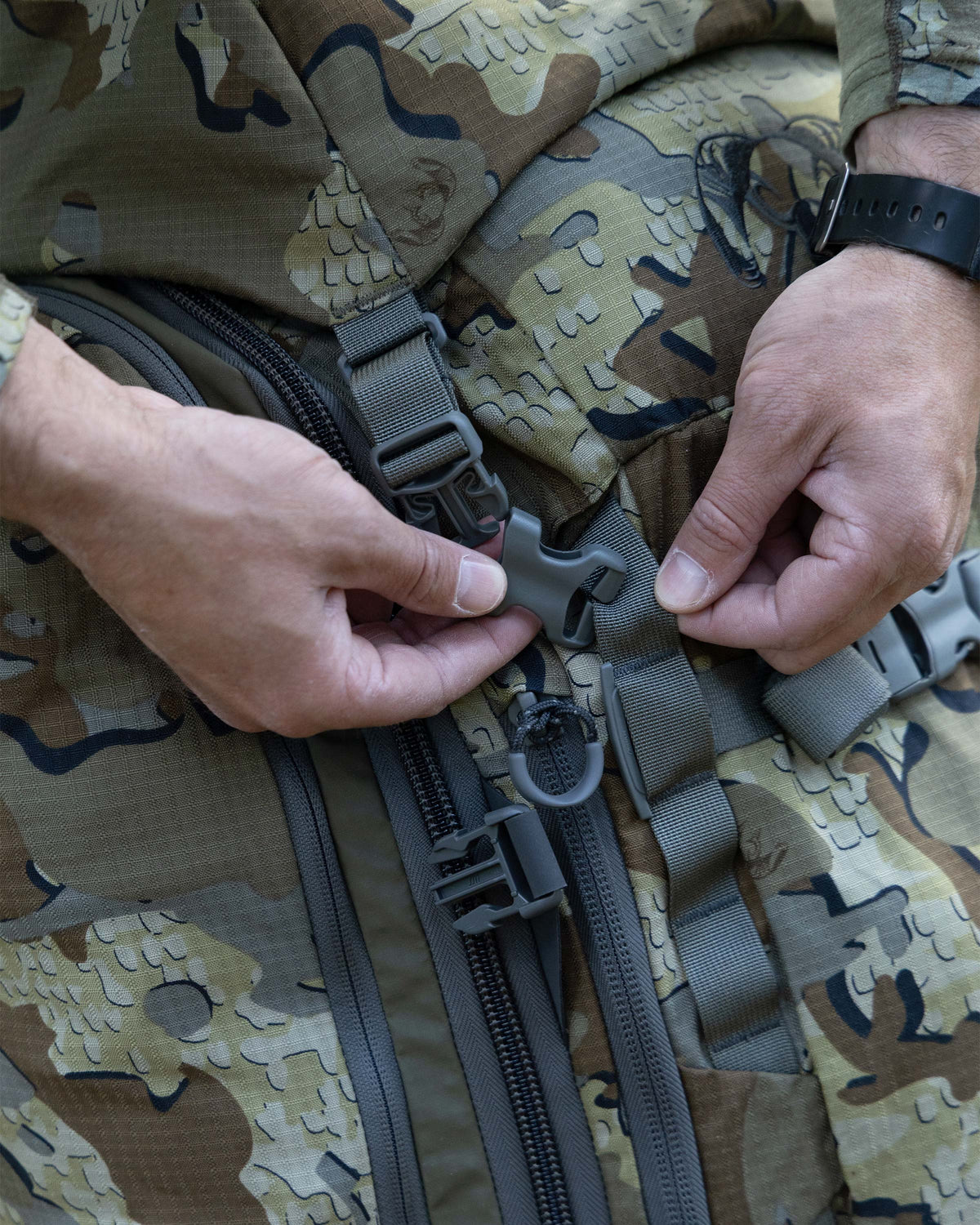 Close-up of adjustable and removable compression straps woven through a daisy-chain webbing system with locking buckles on an ICON 6 6000 Pack in Valo Camouflage.