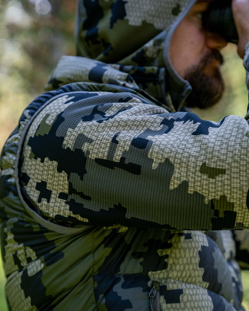 Side of Hunter Glassing with Binoculars in Super Down LT Vest in Verde Camouflage