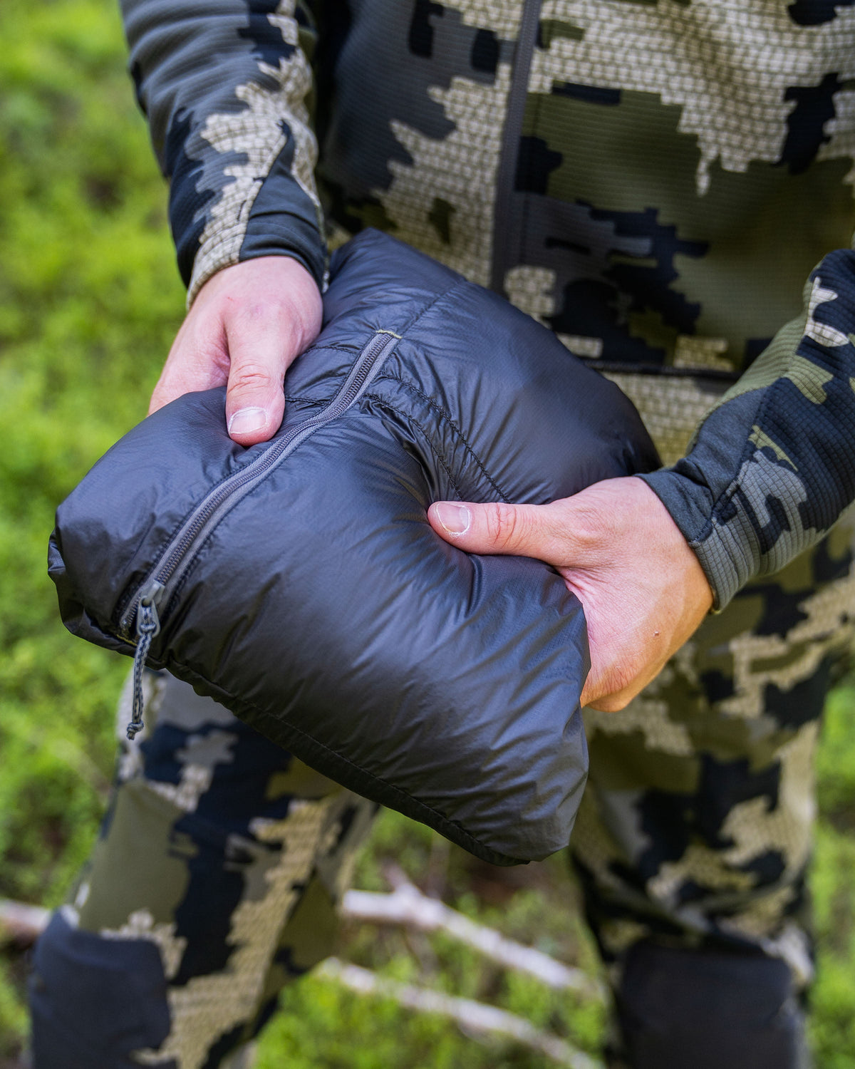 Hunter showing full Self Stow Option zipped on Super Down LT Vest in Verde Camouflage
