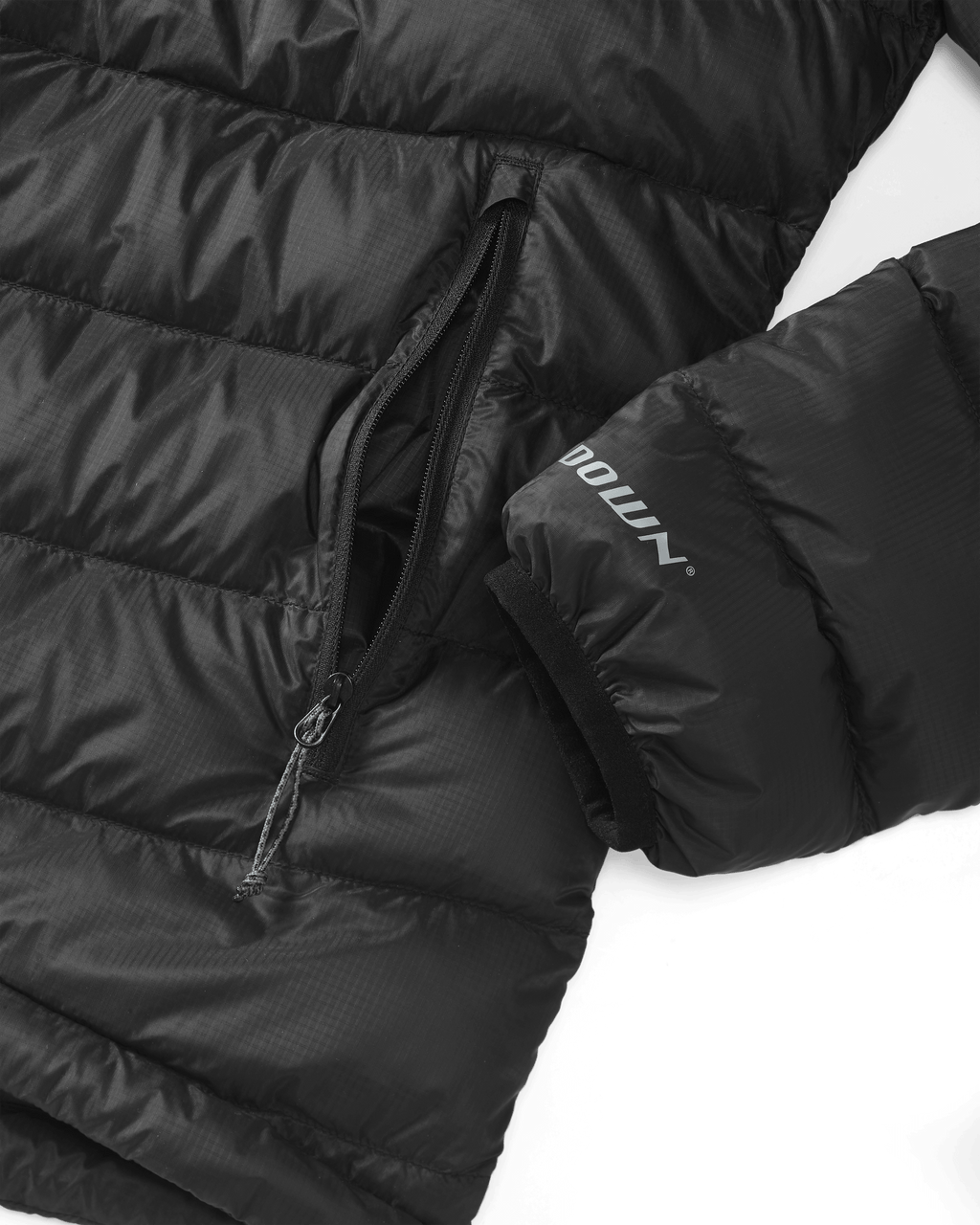 Lower Front of Women's Super Down LT Jacket in Black Highlighting Stretch Bound Wrist Cuff and Zippered Hand Pocket