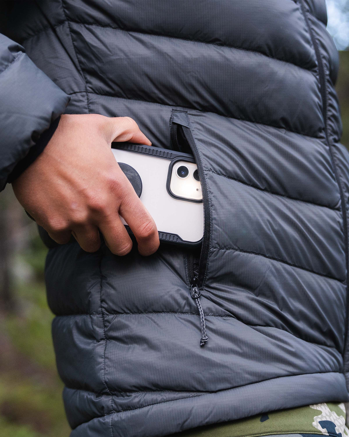 Hunter Removing Phone From YKK Zippered Hand Pocket on Women's Super Down LT Hooded Jacket in Black Color