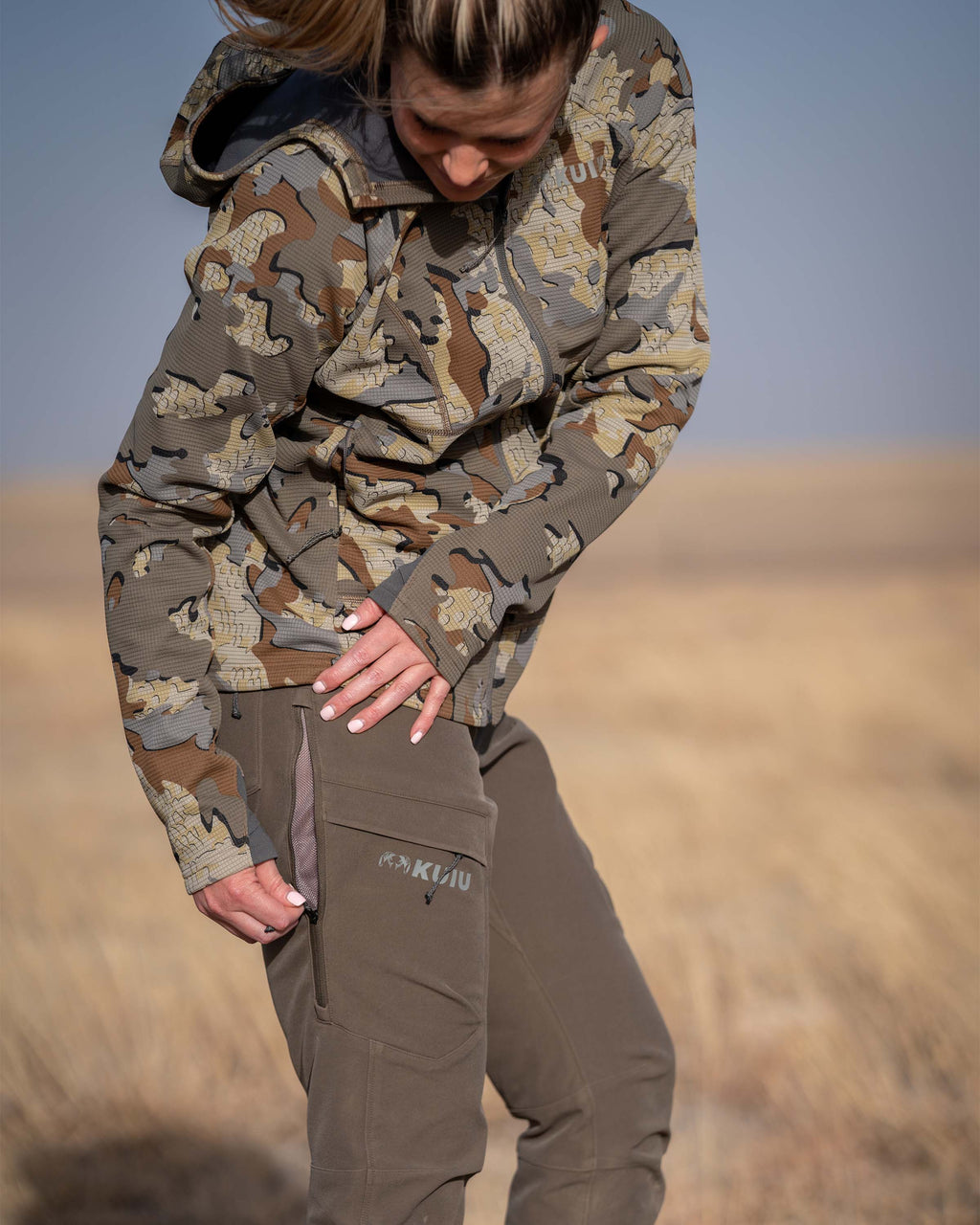 Hunter Wearing Women's Attack Pants in Ash Brown Color Highlighting YKK Zippered Hip Vents.