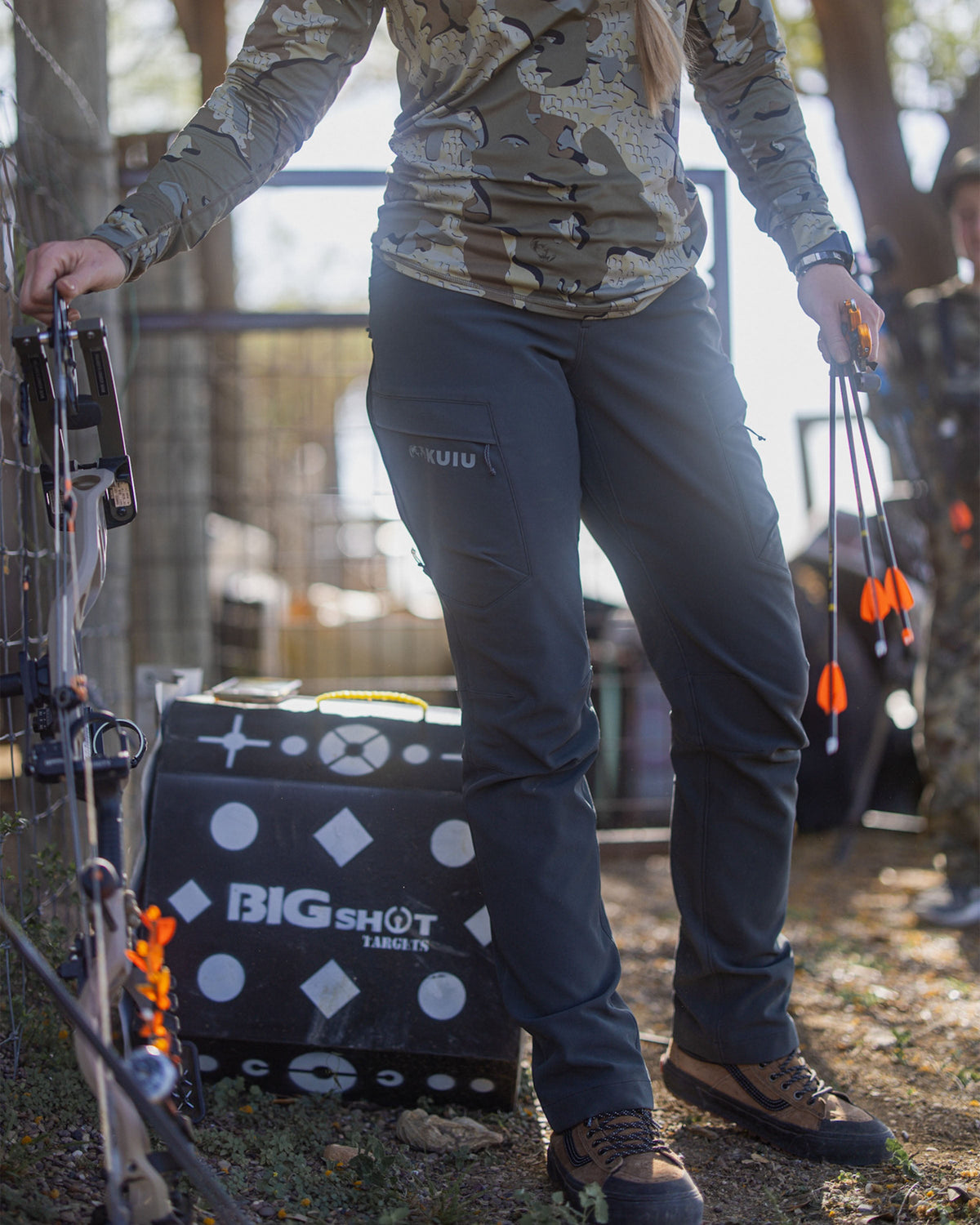 Front of Hunter Holding Bow and Arrows Wearing Women's Attack Pant in Gunmetal Grey Color