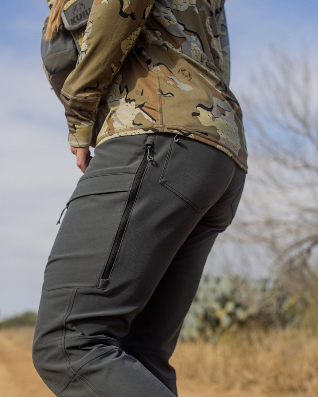 Hunter Wearing Women's Attack Pants in Gunmetal Grey Color Highlighting YKK Zippered Hip Vents