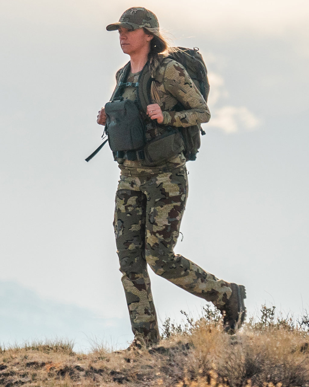 female hunter walking in Women's Attack Pant in Valo Camouflage