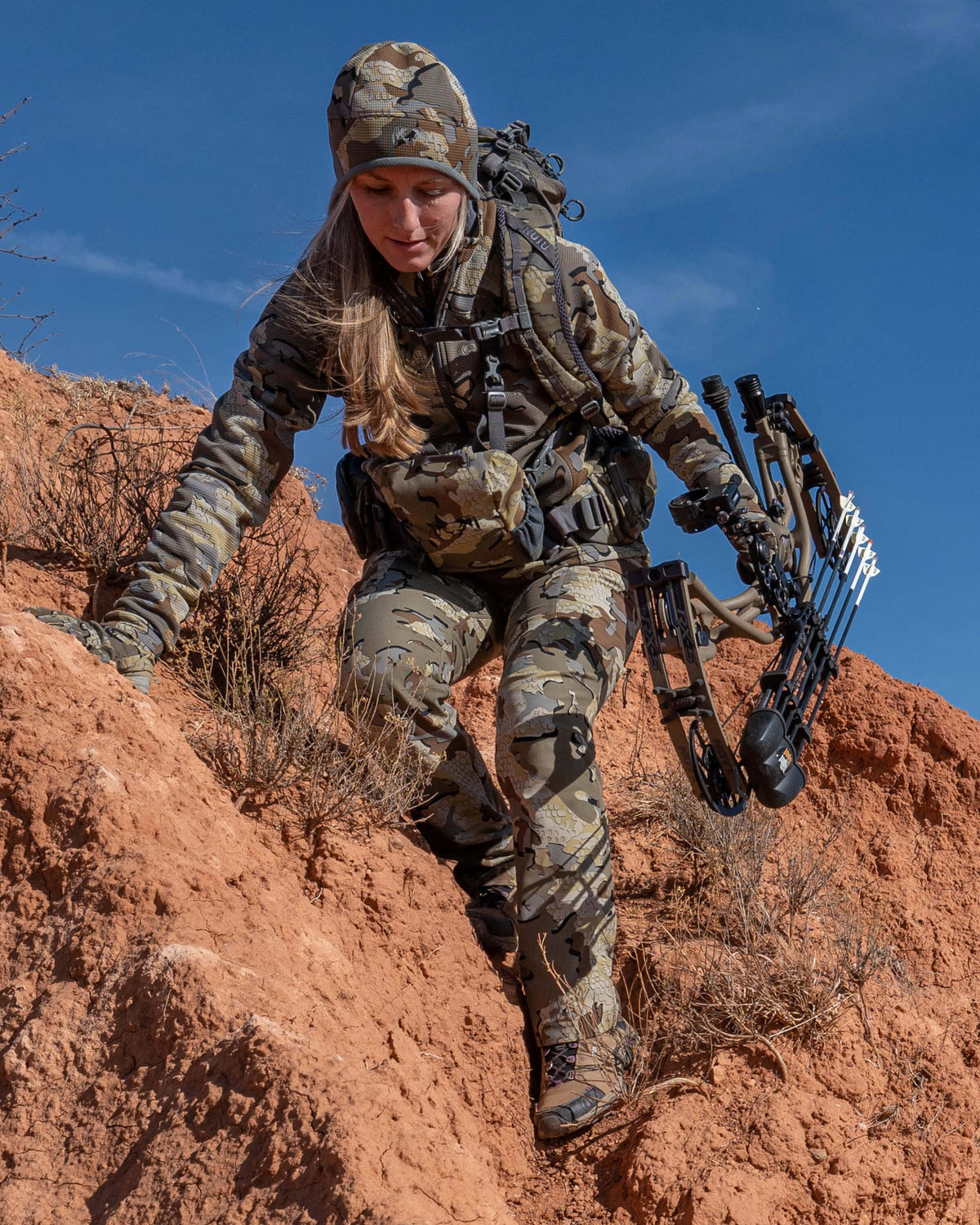 Hunter Side Hilling Through Red Rocks Wearing Women's Attack Pants in Valo Camouflage