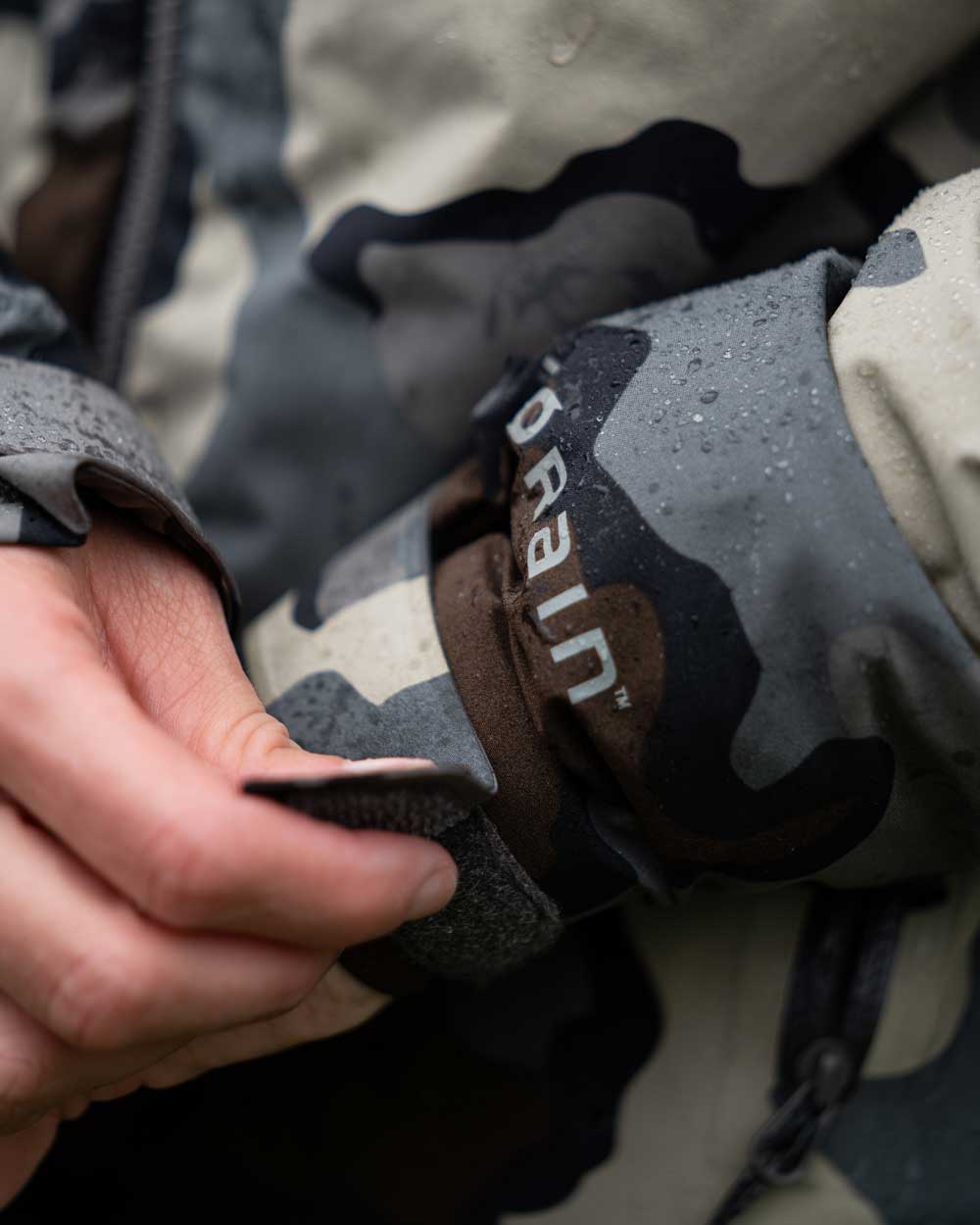 Front, Hunter Closing Adjustable Hoop and Loop Cuffs on Women's Chugach TR Rain Jacket in Vias Camouflage