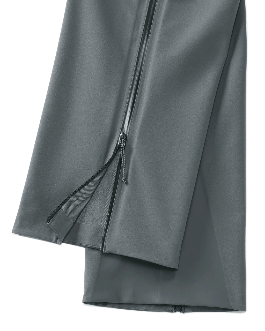 Lower, Side View of Women's Chugach TR Rain Pants in Gunmetal Grey Color Highlighting Full Length YKK Leg Zipper and Bemis Overlay Film Scuff Guards